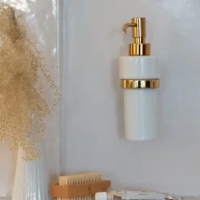 Smedbo-House-Porcelain-Soap-Dispenser-with-Polished-Brass-Holder-Lifestyle.webp