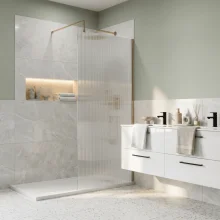 nuie-fluted-800mm-wetroom-screen-with-brushed-brass-support-bar-lifestyle.webp